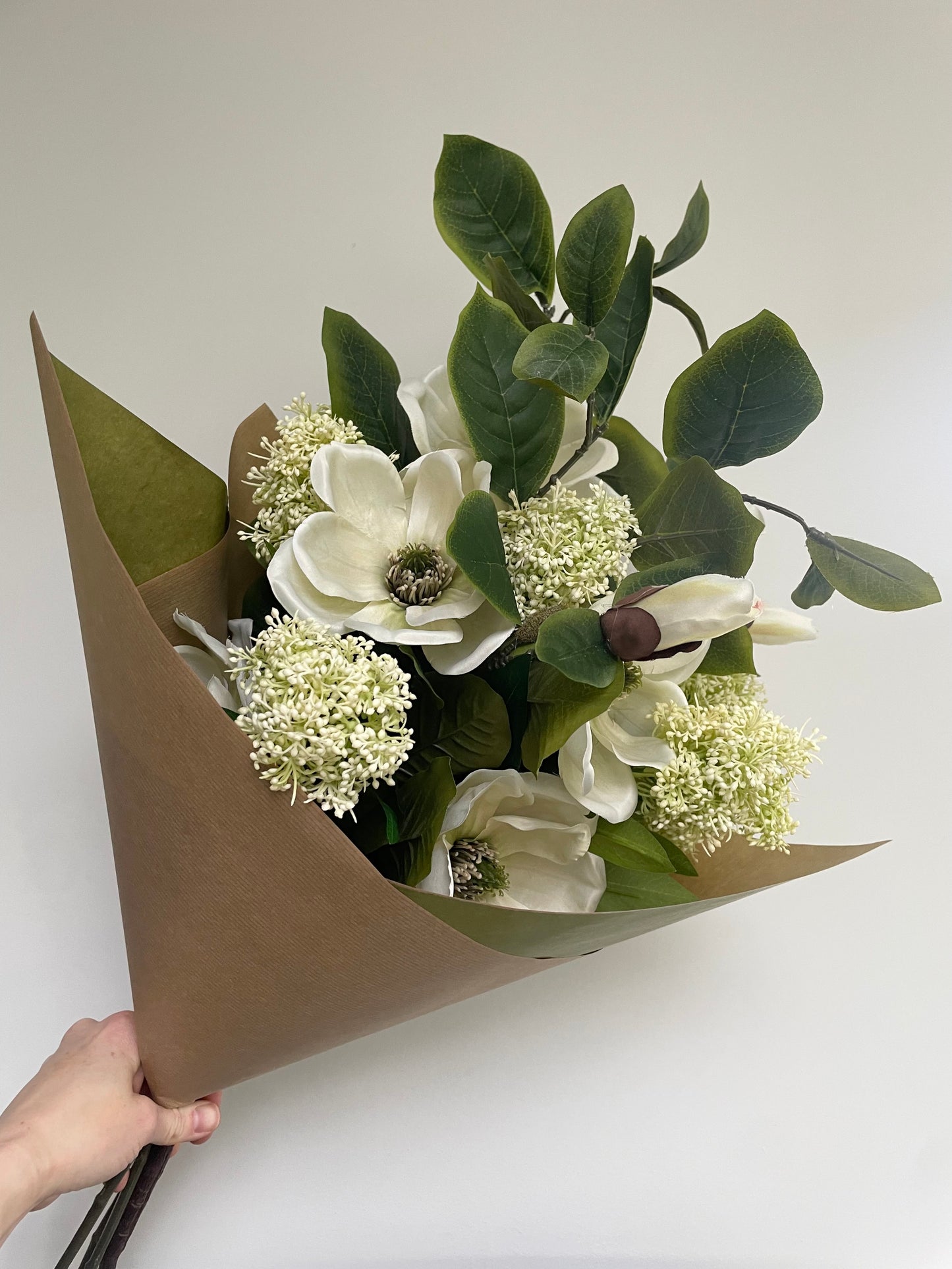 Faux magnolia & skimmia arrangement