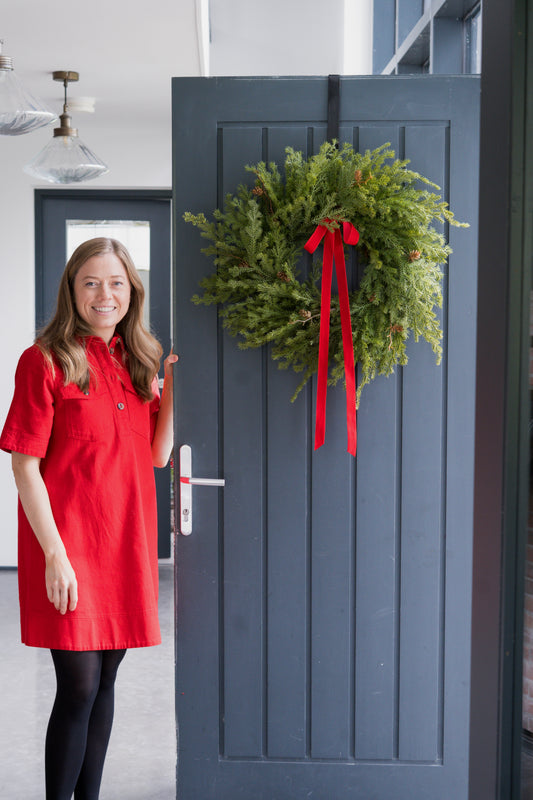 Faux fir wreath with red velvet bow