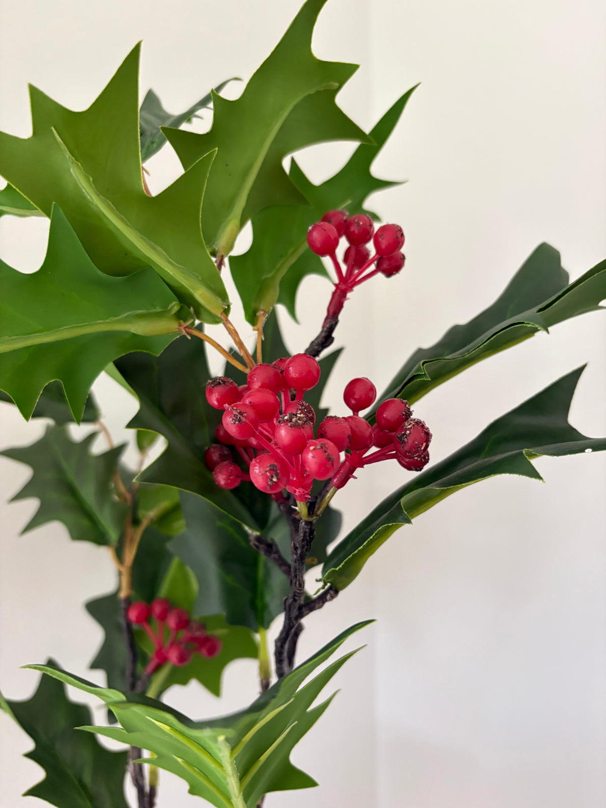 Faux green holly berry stem
