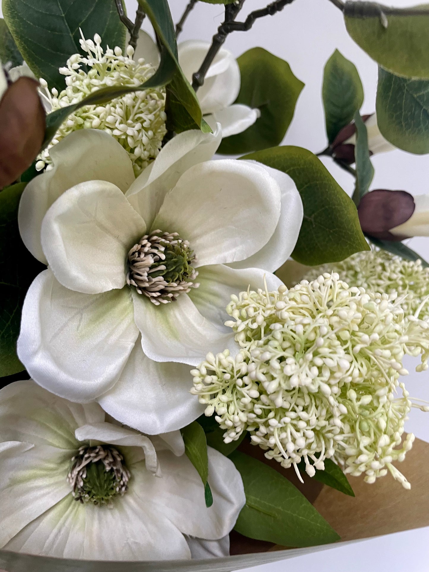 Faux magnolia & skimmia arrangement