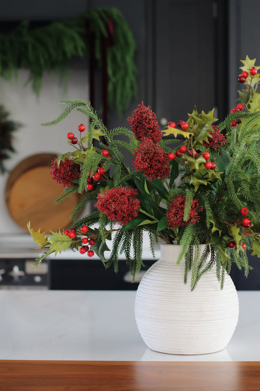 Faux skimmia and holly arrangement